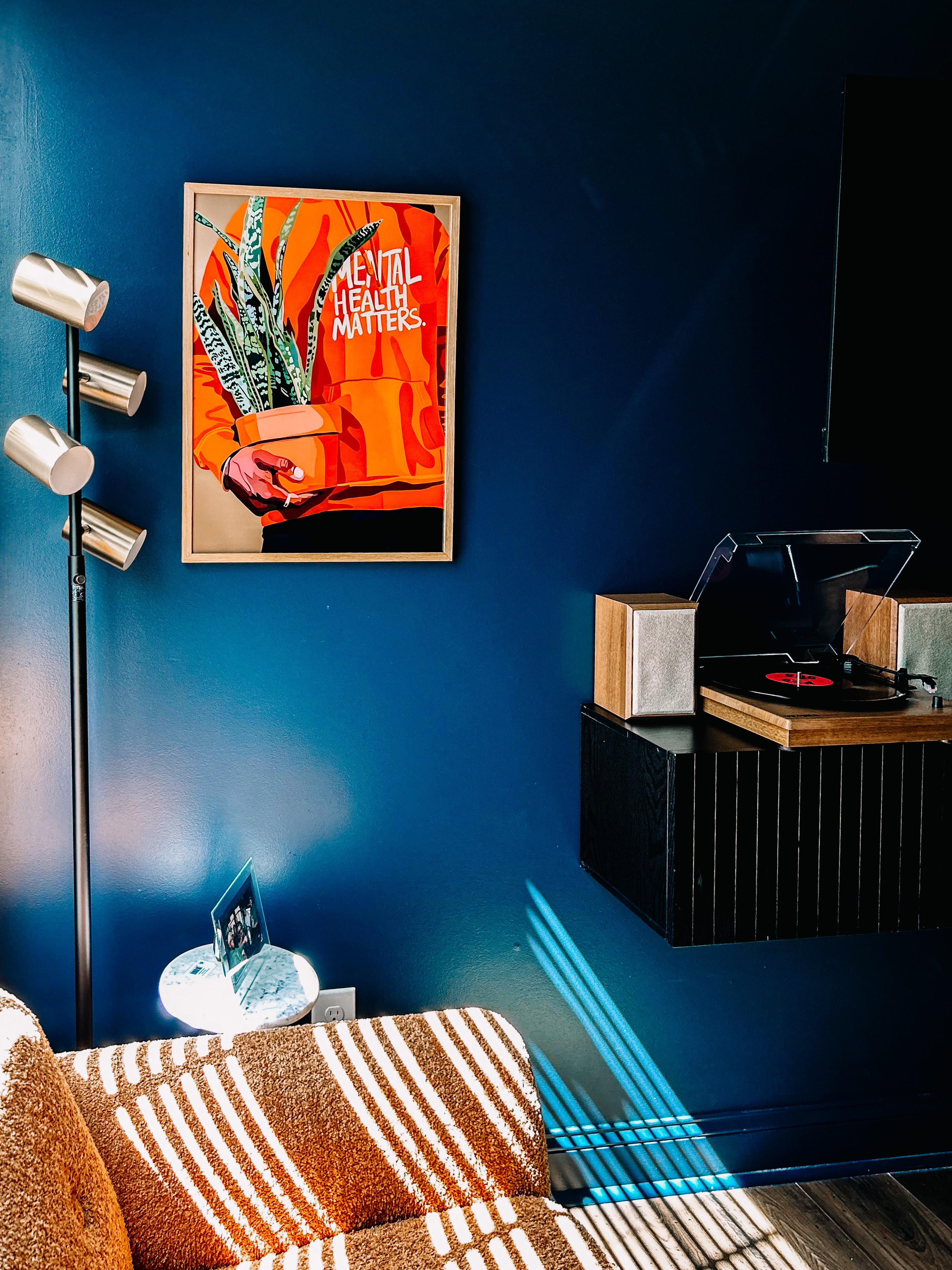 Lounge area with Mental Health Matters art and turntable