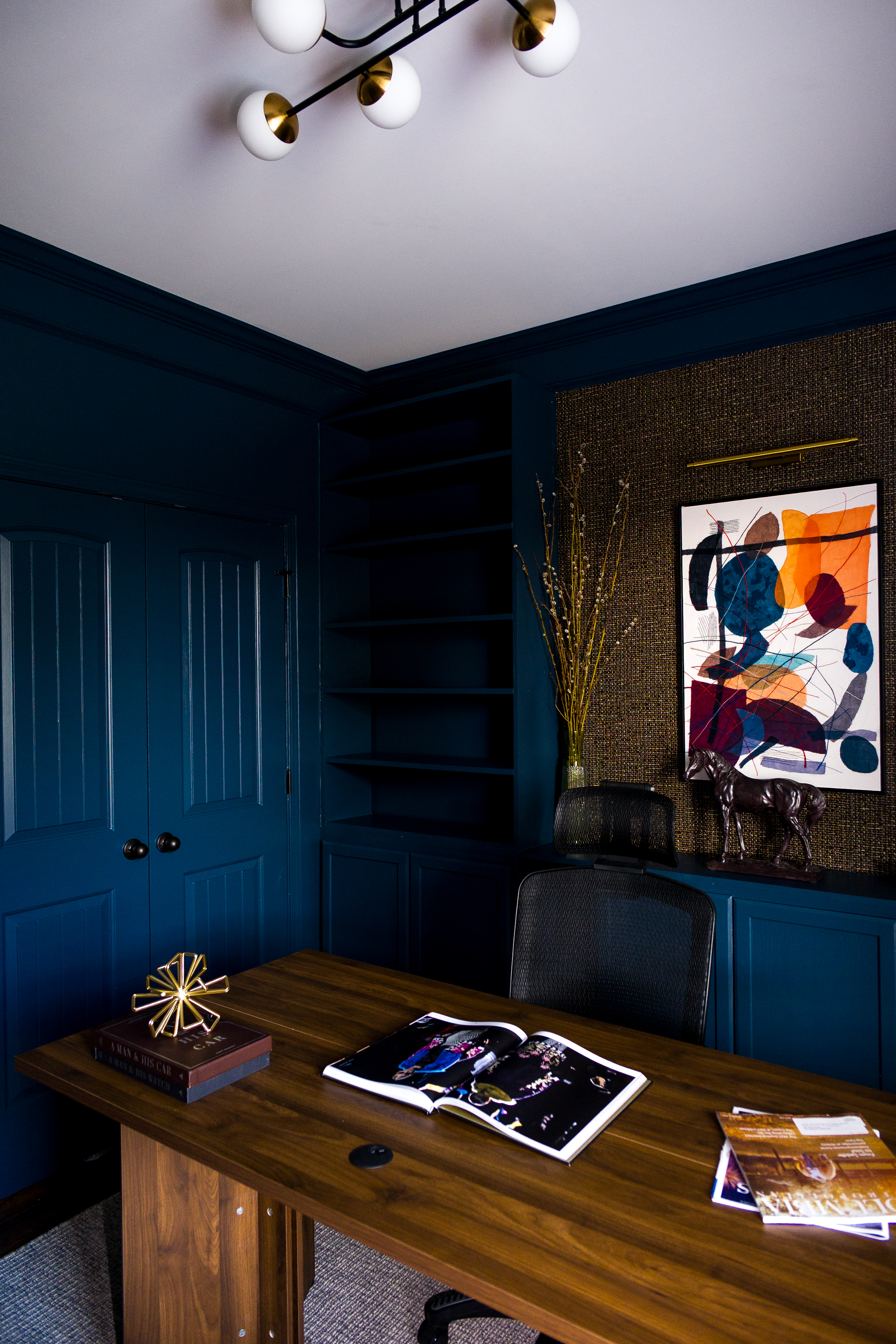Desk with open art books and record wall in background