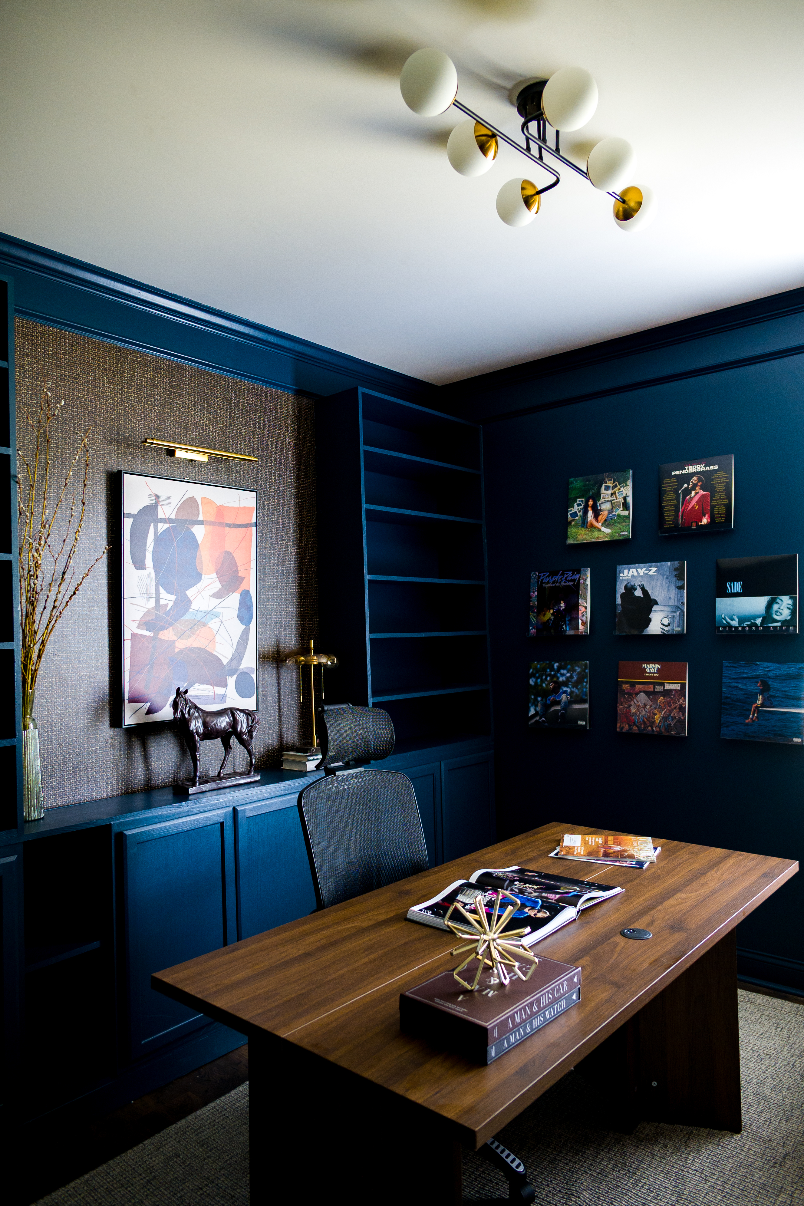 Chris Davis Home Office — deep teal walls with record cover art gallery