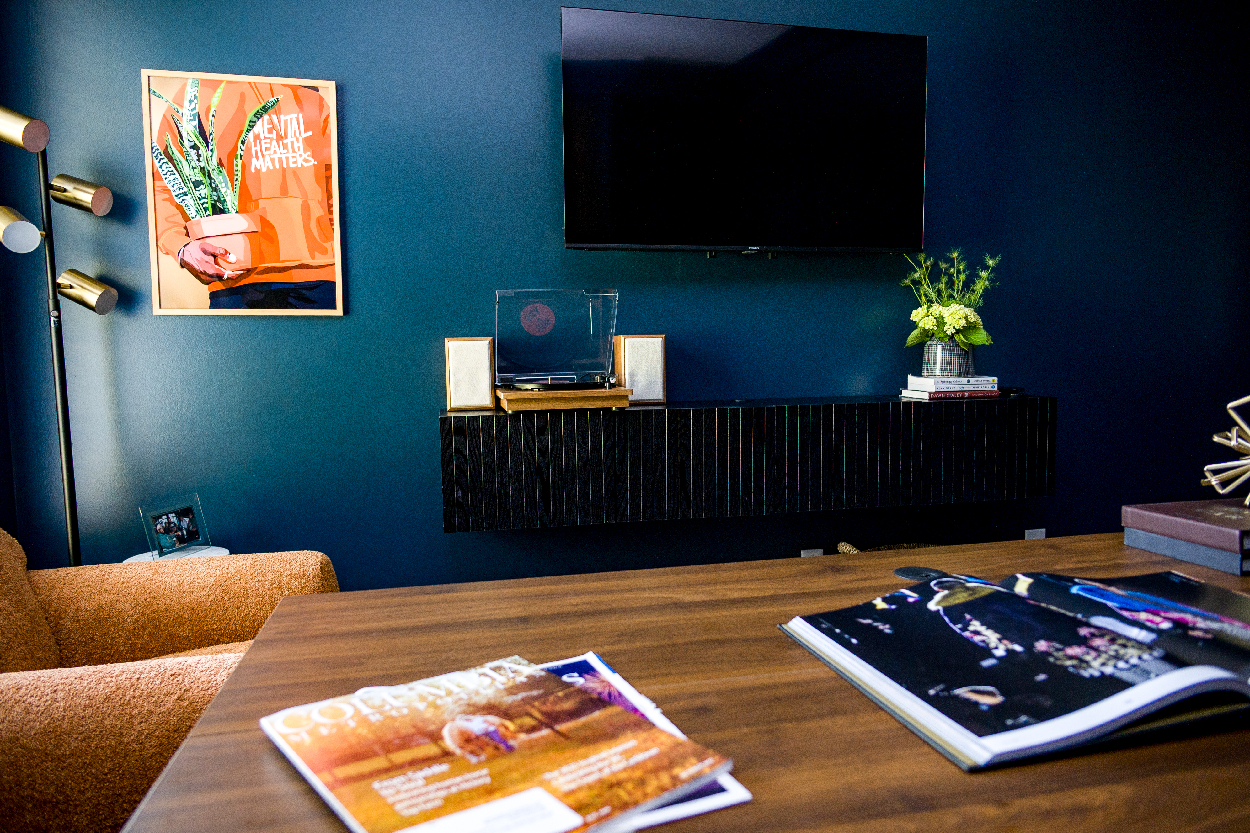 Media wall with turntable, TV, and Mental Health Matters print