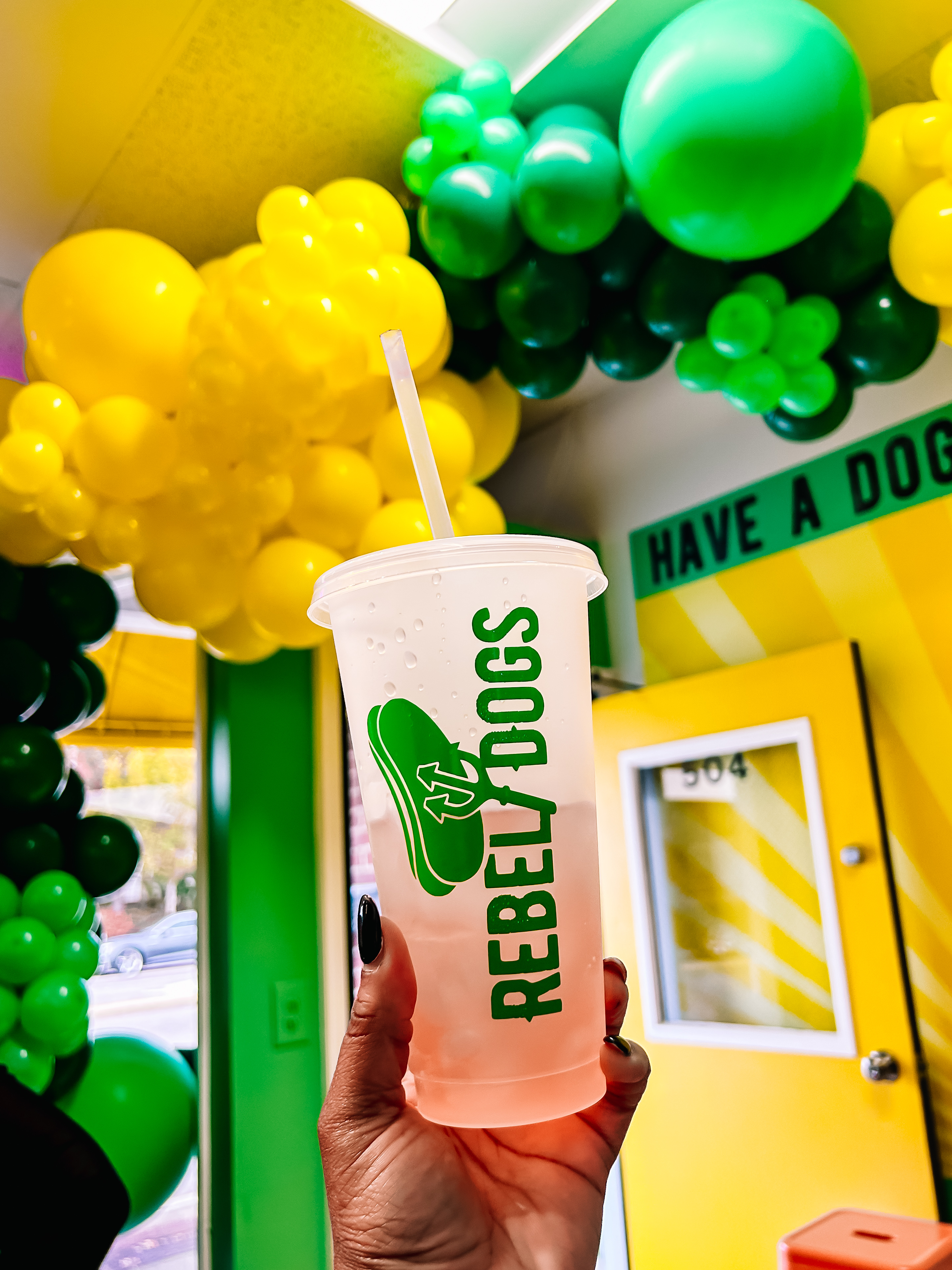 Rebel Dogs branded cup held up against interior